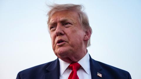 US President Donald Trump speaks to reporters after landing in Air Force One.