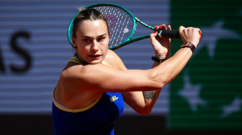 Aryna Sabalenka hits a backhand