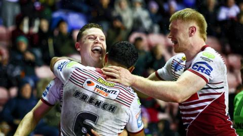 Jay Field celebrates scoring Wigan's sixth try with his team-mates