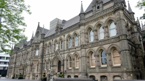 The outside of Middlesbrough Town Hall, a large building with many arched windows.