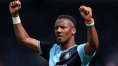 Richard Kone celebrates with both arms aloft after scoring for Wycombe Wanderers