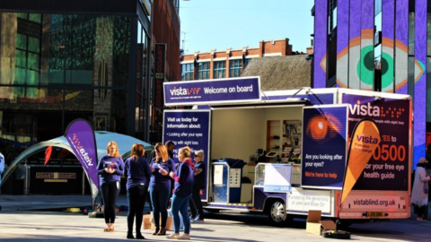 A group of fundraisers next to a van with items inside