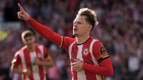 Keane Lewis-Potter celebrates after giving Brentford the lead against Tottenham in the Premier League