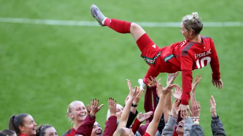 Jess Fishlock thrown in air by teammates at full time