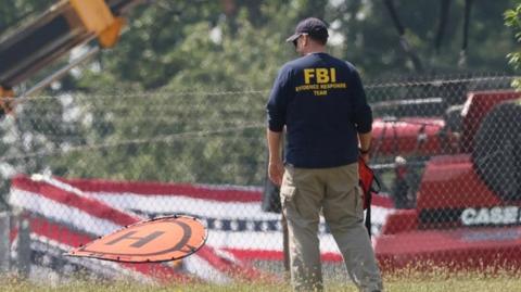 A member of the FBI Evidence Response Team, works near the building where a gunman was shot dead by law enforcement