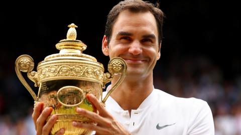 Roger Federer holds the Wimbledon men's singles trophy