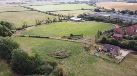 Country land with houses and agricultural buildings