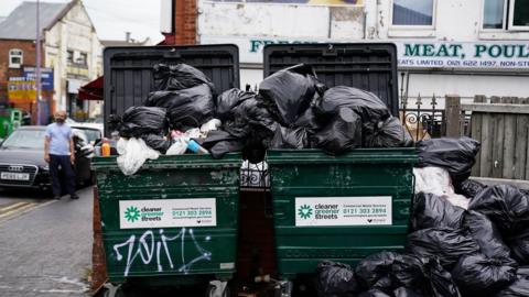 Uncollected refuse bags in the Aston area of Birmingham. The Unite union has warned that the Birmingham bin dispute could last until December after workers voted to continue industrial action in a long-running dispute over jobs and pay.