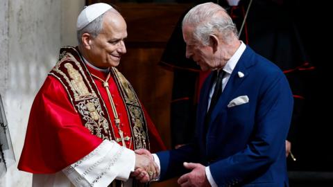 Pope and King shake hands
