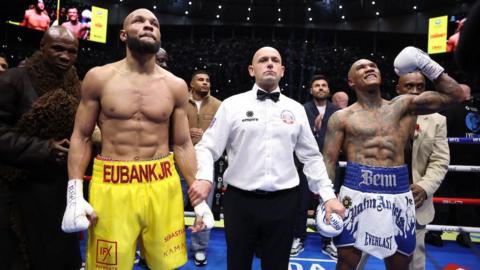Conor Benn celebrates and Chris Eubank Jr looks up with the referee in the middle following the conclusion of their rematch