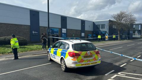 Police cars and cordon at the scene 