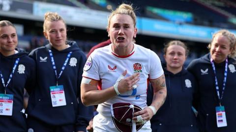England captain Meg Jones talks to her team on the pitch