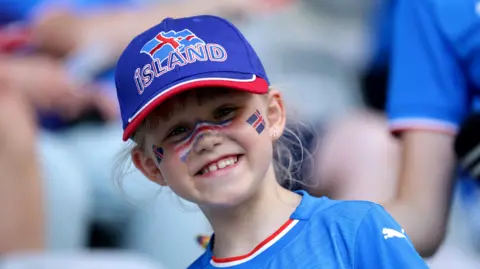 An Iceland fan smiles at the camera