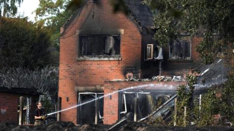 The burnt out remains of houses following a huge blaze in Stourbridge, in the West Midlands