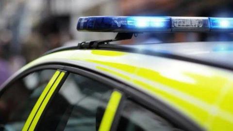 A police car with its blue lights on