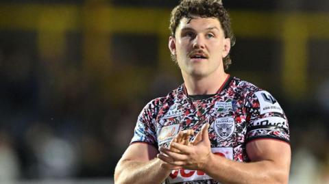 Robbie Mulhern claps the Leigh Leopards fans after a Super League match at Castleford Tigers