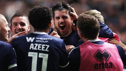 Millwall players celebrate a goal against Stoke