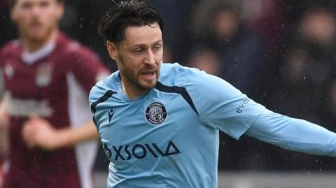 A close up of Harry Cornick in action. He is wearing the sky blue away kit of Stevenage.