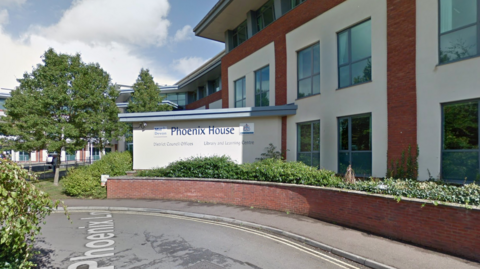 A picture of Mid Devon District council offices. It is a white and brick building with a sign in front reading Phoenix House.