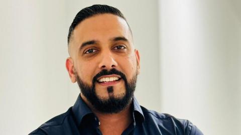 Image of Gurvinder Singh Johal. He has dark hair and a dark beard