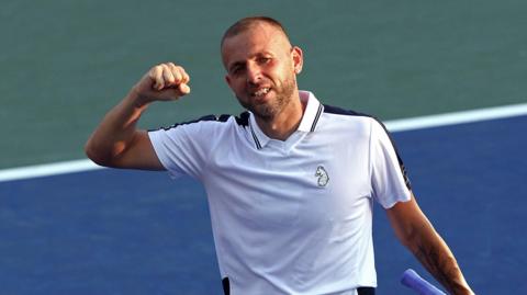 Dan Evans celebrates beating Karen Khachanov