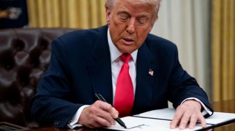 US President Donald Trump signs an executive order