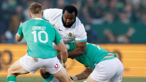 Ox Nche is tackled by Jack Crowley