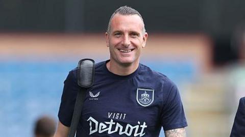 Nicky Hayen smiles as he walks inside Turf Moor