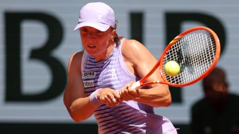 Iga Swiatek hits a backhand