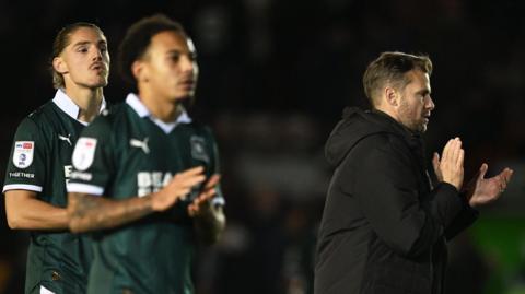 Dejected Plymouth Argyle players walk off the pitch