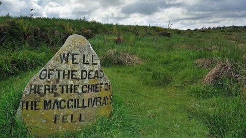 A grave marker reading "Well of the dead. Here the Chief of the MacGillivrays Fell".