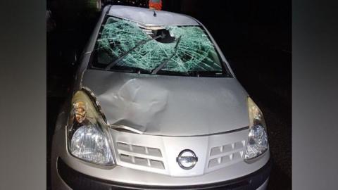 Silver Nissan car with a smashed windscreen