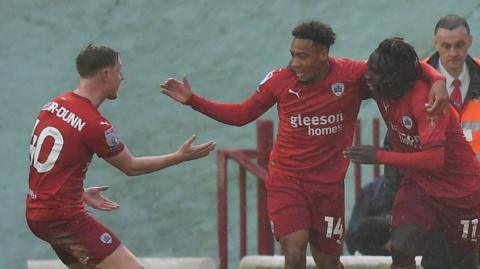 Jonathan Lewis celebrates scoring Barnsley's equaliser against Cambridge