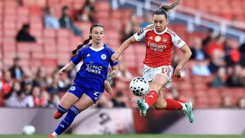 Katie McCabe jumps to control the ball