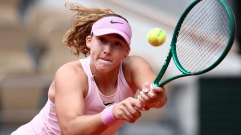 Mirra Andreeva hits a backhand
