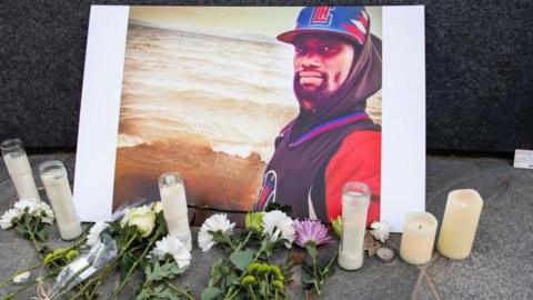  A photograph of Tyre Nichols is displayed at a memorial