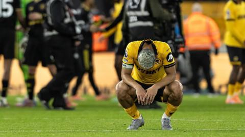 Andre crouches down after Wolves' defeat to Manchester United