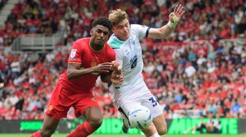Freddie Draper of Lincoln City vies for possession with Adilson Malanda of Middlesbrough during the Sky Bet Championship 2026-27 match between Middlesbrough and Lincoln City