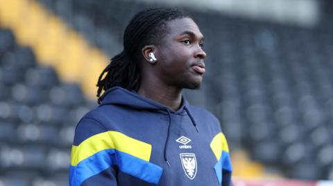 AFC Wimbledon player Osman Foyo looks on ahead of his game for the Dons 