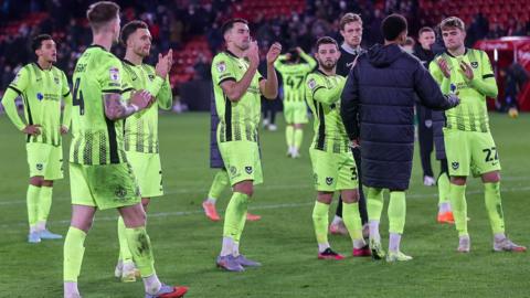 Portsmouth players look dejected as they applaud the travelling fans after the 3-0 defeat at Sheffield United