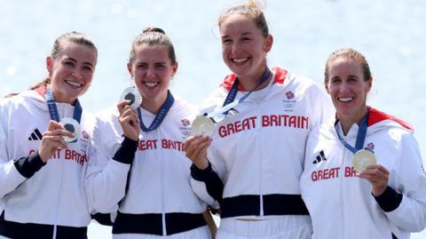 Helen Glover (right) and the women's four receive their medals