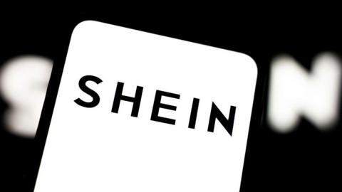 Black Shein logo on a white background on a smartphone screen 