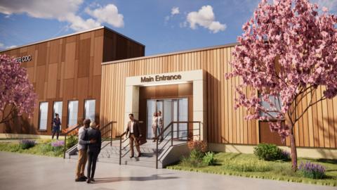 A computer generated image of what the new diagnostic centre will look like. It is a large rectangular building clad in wooden planks. There are a set of stone steps leading up to an entrance with automatic doors. There are two cherry blossom trees growing on either side of the entrance on a patch of grass and flowers.