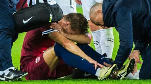 Martin Odegaard sat down receiving treatment after getting injured while playing for Norway against Austria