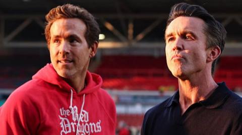 Ryan Reynolds and Rob McElhenney looking at the camera