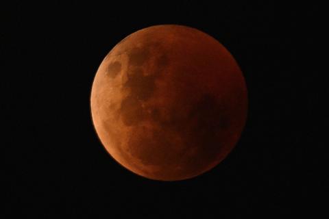 Blood red moon shines in the night's sky