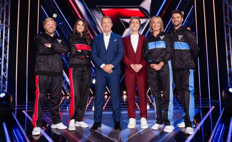 rob beckett ellie taylor bradley walsh barney walsh louise minchin and joel dommett stand together smiling on the gladiators set