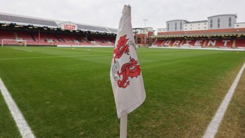 A Leyton Orient-branded corner flag at Brisbane Road