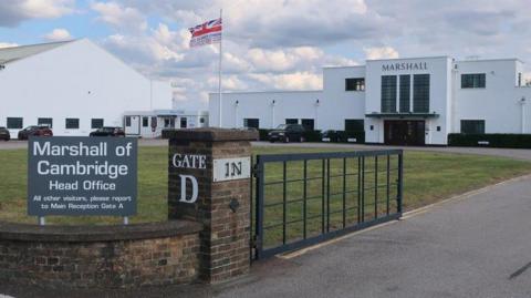 A sign saying Marshall of Cambridge head office outside the company's Cambridge base