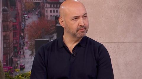 A man wearing a black shirt sat in the Morning Live tv studio.